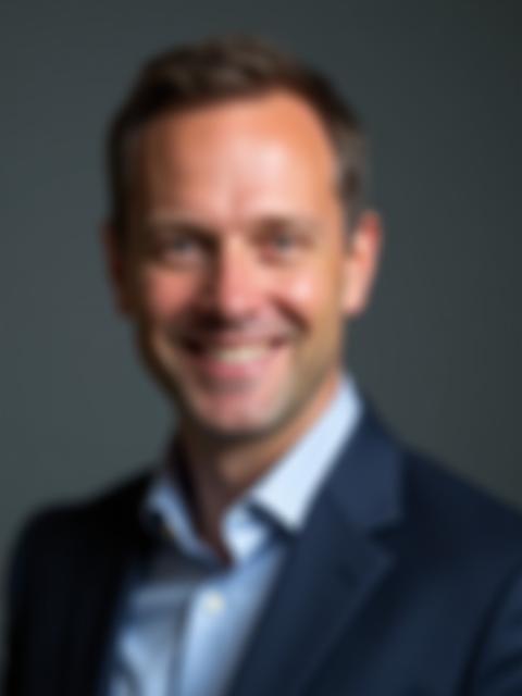 Corporate headshot of a male executive